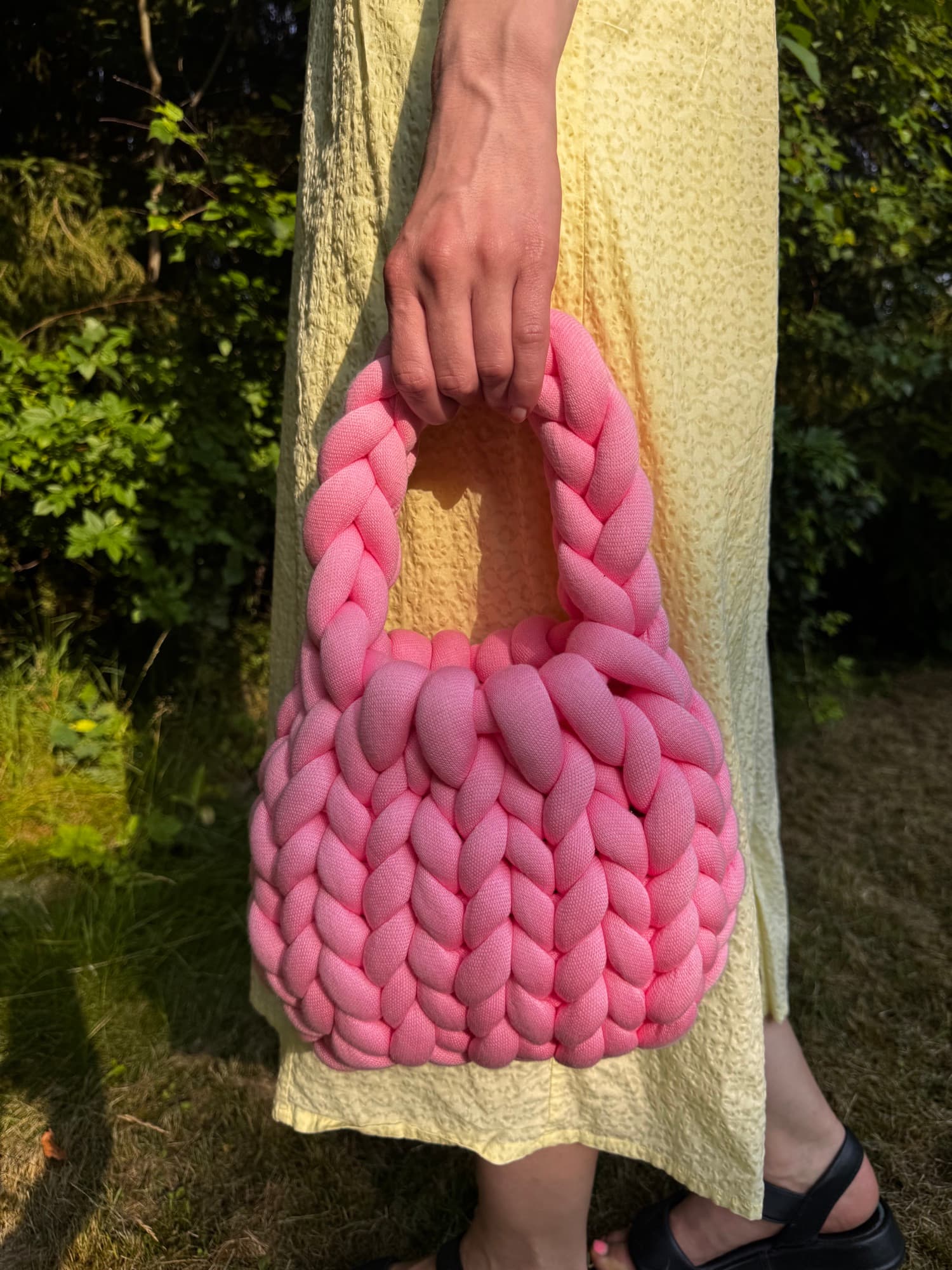 Macro close-up of pink crochet stitches, the texture of a MALLA bag.